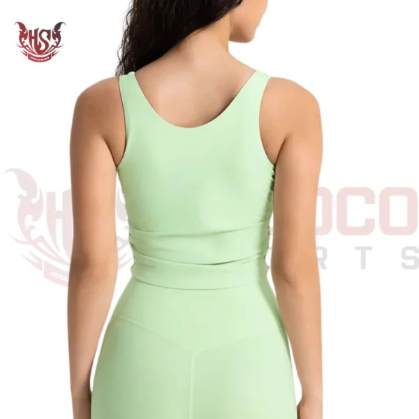 Full-coverage light green sports bra with rounded neckline, ideal for yoga backside